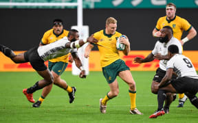 Australia's wing Reece Hodge is tackled during the Japan 2019 Rugby World Cup Pool D match between Australia and Fiji at the Sapporo Dome.