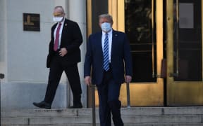 US President Donald Trump walks out of Walter Reed Medical Center in Bethesda, Maryland, to return to the White House.