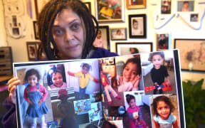 Tracey Elvins holds images of her daughter Hineihana Sosefina Mausii. (File photo).