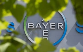 A logo of German pharmaceutical giant Bayer appears on an overpass at its Berlin headquarters July 24, 2013.