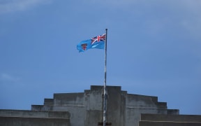 The flag of Fiji flies atop the parliament buildings in Suva.