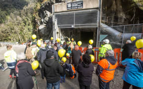 Families gather at the entrance to the mine for the re-entry yesterday.
