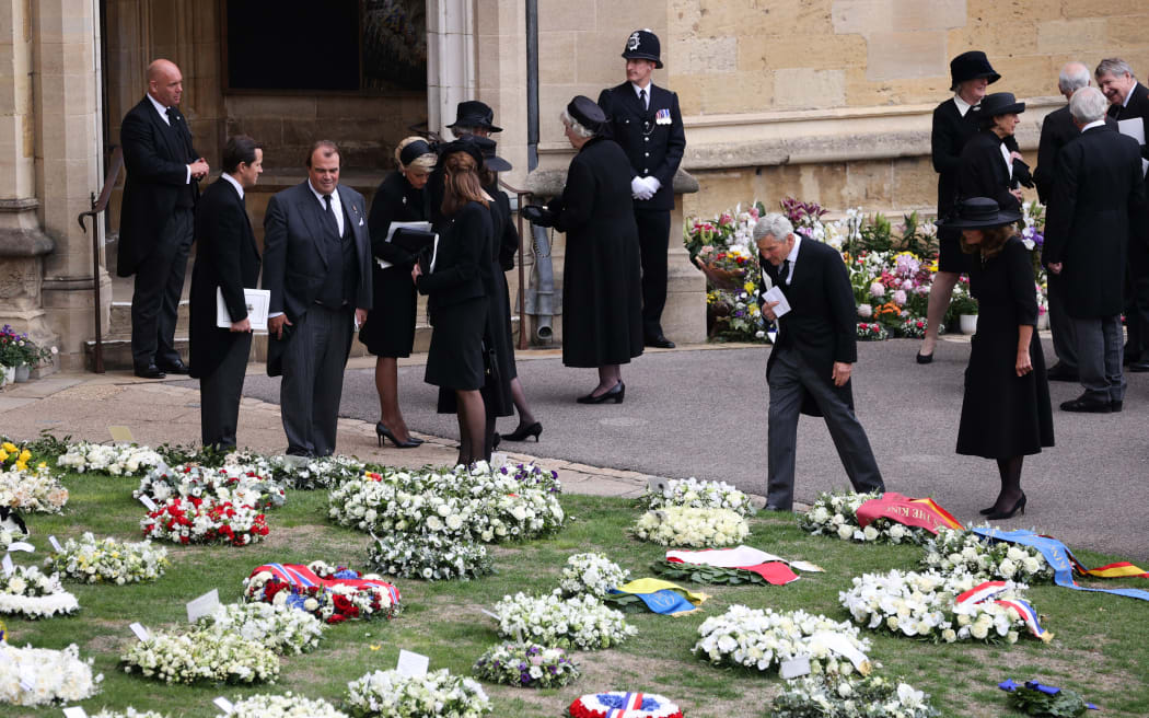 Carole Middleton (R) and Michael Middleton (2nd R) look at floral wreaths ahead of the Committal Service for Britain's Queen Elizabeth II in St George's Chapel, inside Windsor Castle on September 20, 2022.