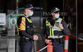 Police stand guard at a hotel in Melbourne in early December, where Australians returning from overseas will quarantine as part of precautions against Covid-19.