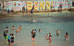 Sunbathers cool off on Bondi Beach as temperatures soar in Sydney