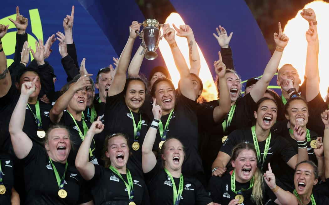 New Zealand's players lift the trophy after winning the Rugby World Cup final match between New Zealand and England at Eden Park in Auckland.