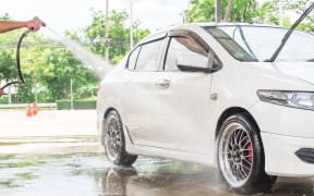 Car wash with flowing water and foam