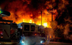 ATLANTA, USA - JUNE 13: Demonstrators set on fire a restaurant during the protest after an Atlanta police officer shot and killed Rayshard Brooks, 27, at a Wendy's fast food restaurant drive-thru Friday night in Atlanta, United States on June 13, 2020.