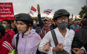 Pro-democracy protesters march toward  Government House during an anti government demonstration on October 14, 2020 in Bangkok, Thailand.