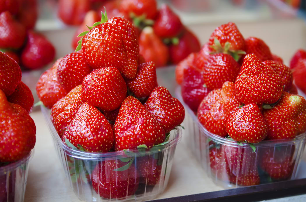 Fresh strawberry at market in plastic boxes.