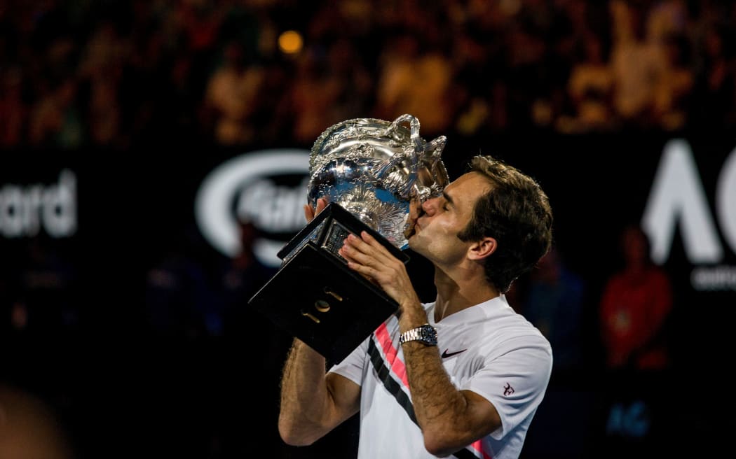 Roger Federer kisses his trophy after winning the Final in the 2018 Australian Open