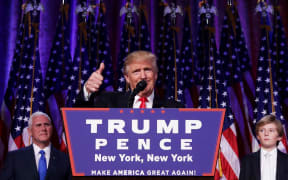 Republican president-elect Donald Trump gives a thumbs up to the crowd during his acceptance speech at his election night event at the New York Hilton Midtown in the early morning hours of November 9, 2016 in New York City.