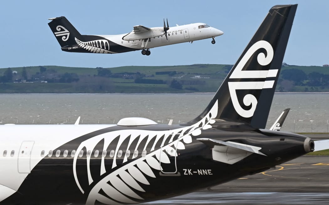 A photo taken on August 9, 2021 shows an Air New Zealand plane taking off from Auckland Airport with the national carrier managing to cut its losses by a third in the last financial year