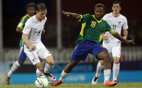 Solomon Islands captain Henry Fa'arodo challenges for the ball against New Zealand at the OFC Nations Cup.