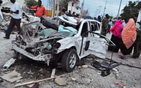 Damaged car at the scene of an explosion in Mogadishu, Somalia