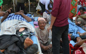 Nepalese patients lie on stretchers following the quake.