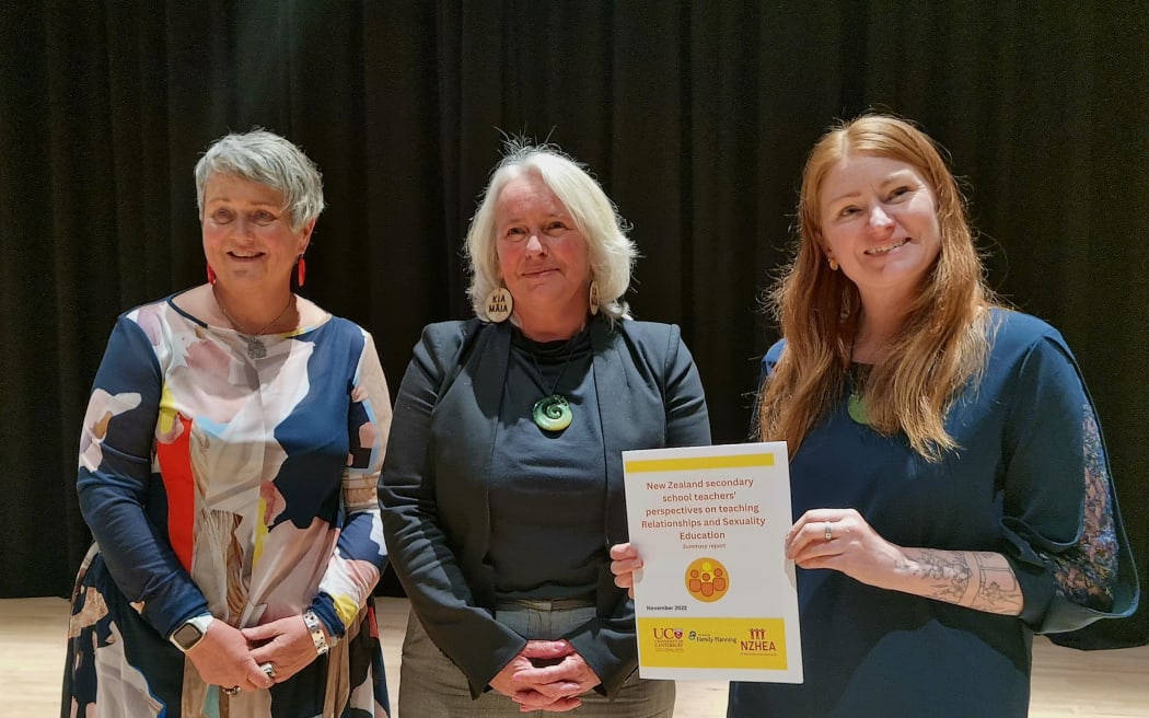 Jackie Edmond, chief executive of Family Planning; Catherine Law, Avonside Girls' principal; and Dr Rachael Dixon, the lead author of the survey. They are posing with a copy of the results summary.