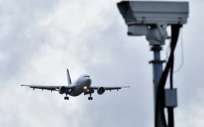 An aircraft prepares to land at London Gatwick Airport after flights resumed following the closing of the airfield due to sightings of drones.