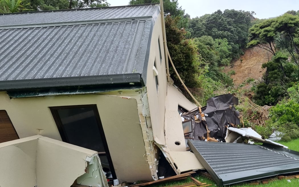 A house hit by a landslide in Muriwai