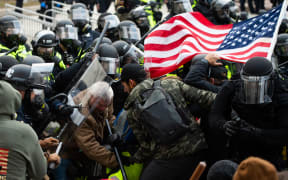 Supporters of US President Donald Trump fight with riot police outside the Capitol building on 6 January 2021 in Washington DC.