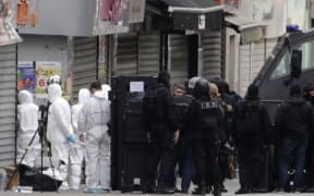 Police and forensics teams in Saint-Denis after the raids.