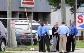 Investigators work the scene of a multiple shooting at an area business in an industrial area on June 5, 2017 northeast of downtown Orlando, Florida.