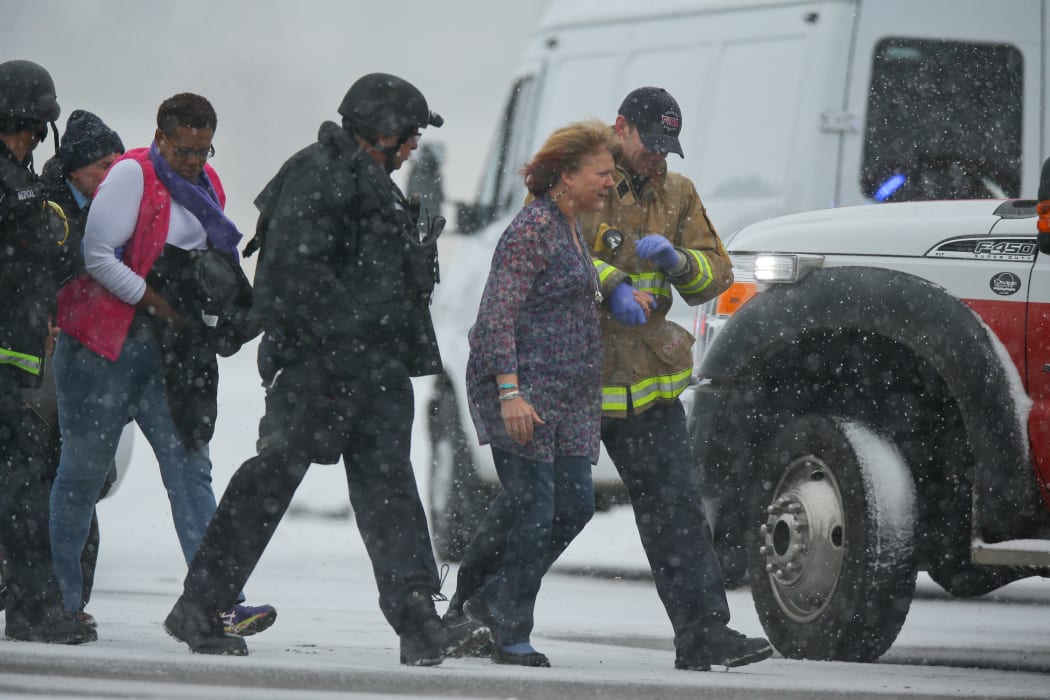 Hostages are escorted to safety during an active shooter situation outside a Planned Parenthood facility