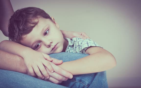 49451379 - A photo of a sad son hugging his mother at home. concept of couple family is in sorrow.