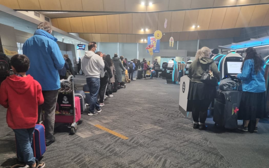 People queuing at Wellington Airport after all flights in and out of the capital were cancelled on 21 July 2022 due to the weather.