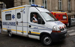 An ambulance leaves a building requisitioned to treat injured people, near the site of the accident at Parc Monceau in Paris.