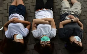 Hong Kong pro-democracy demonstrators rest after a night of protesting.