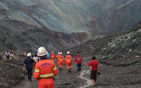Rescuers attempting to locate survivors after a landslide at a jade mine inthe  Hpakant of Kachin state.