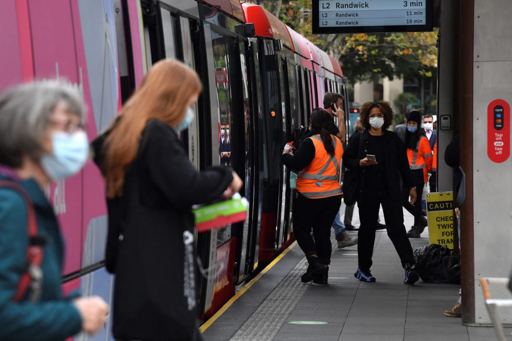 Passengers wearing face masks alight from a metro in Sydney on June 23, 2021, as residents were largely banned from leaving the city to stop a growing outbreak of the highly contagious Delta Covid-19 variant spreading to other regions.