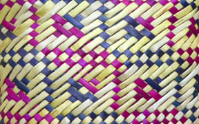 Flax-woven Kete with bright purple and blue details, woven by Riperata McMath, www.kuragallery.co.nz