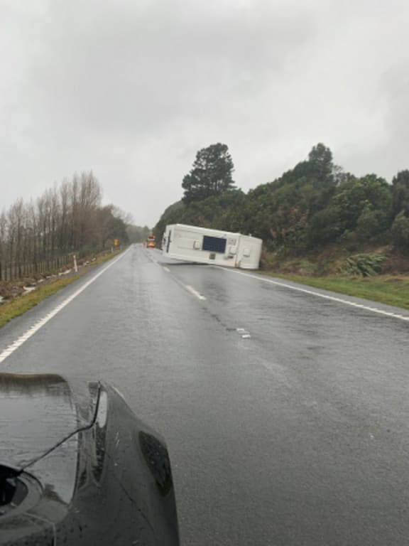 A campervan on its side is blocking southbound lane approximately 2 kilometres south of Te Haroto.