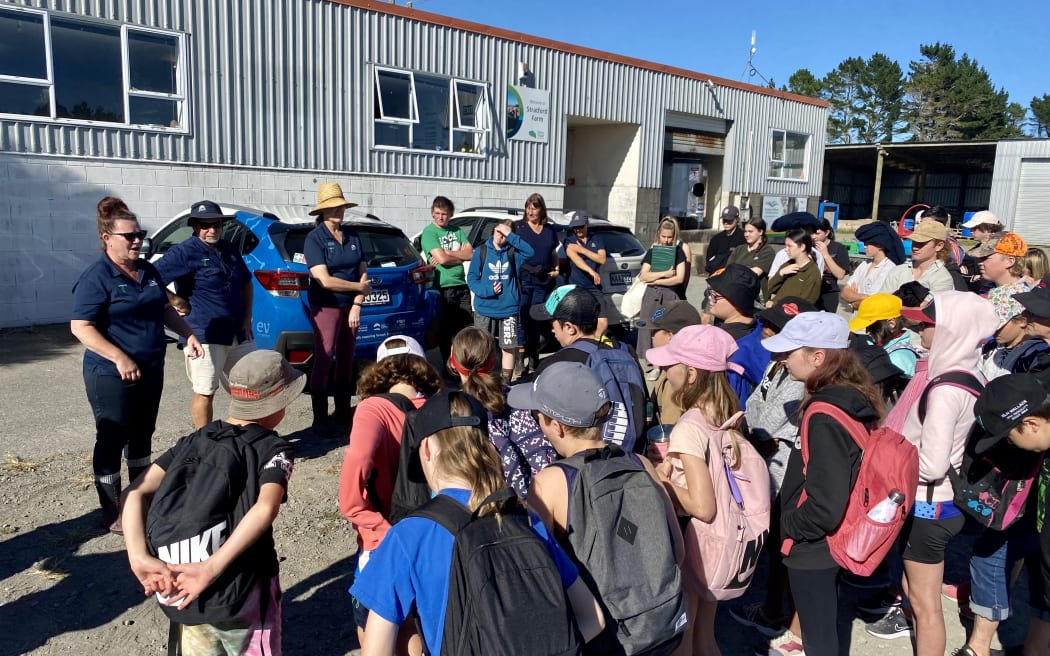 Enviroschools Stratford Primary and Stratford High School gather in front of the Dairy Trust office to hear plan for the day.