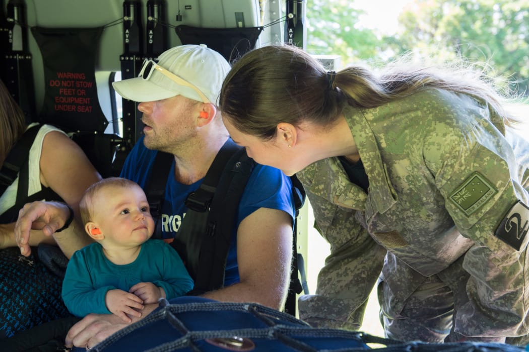 New Zealand Defence personnel help evacuees settle in for their journey away from quake-stricken Kaikoura.