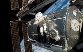 NASA astronaut Rex Walheim performs a space walk outside the International Space Station on 15 February 2008.
