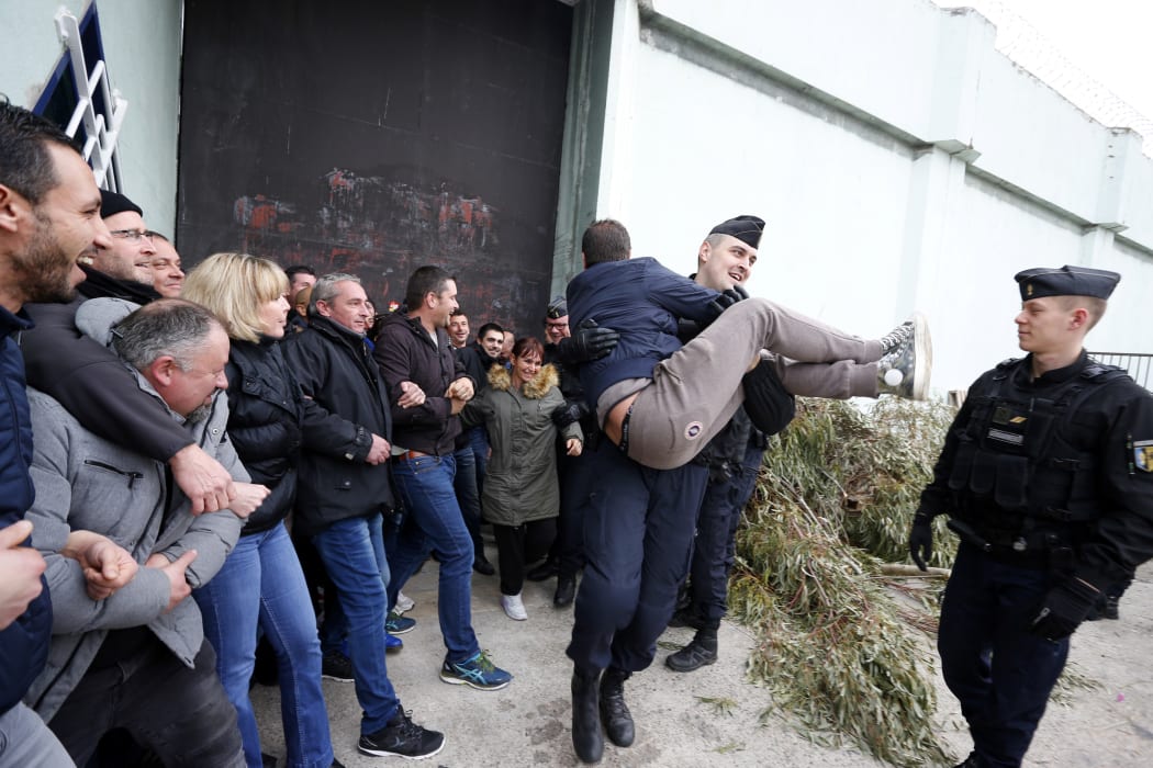 Riot police evacuate striking prison guards blocking the access to Borgo prison  on Corsica island on Monday 22 January, 2018.
