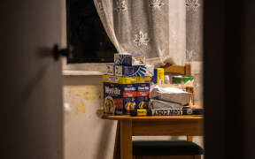 Fresh groceries sit on the kitchen table of a low income family's home.