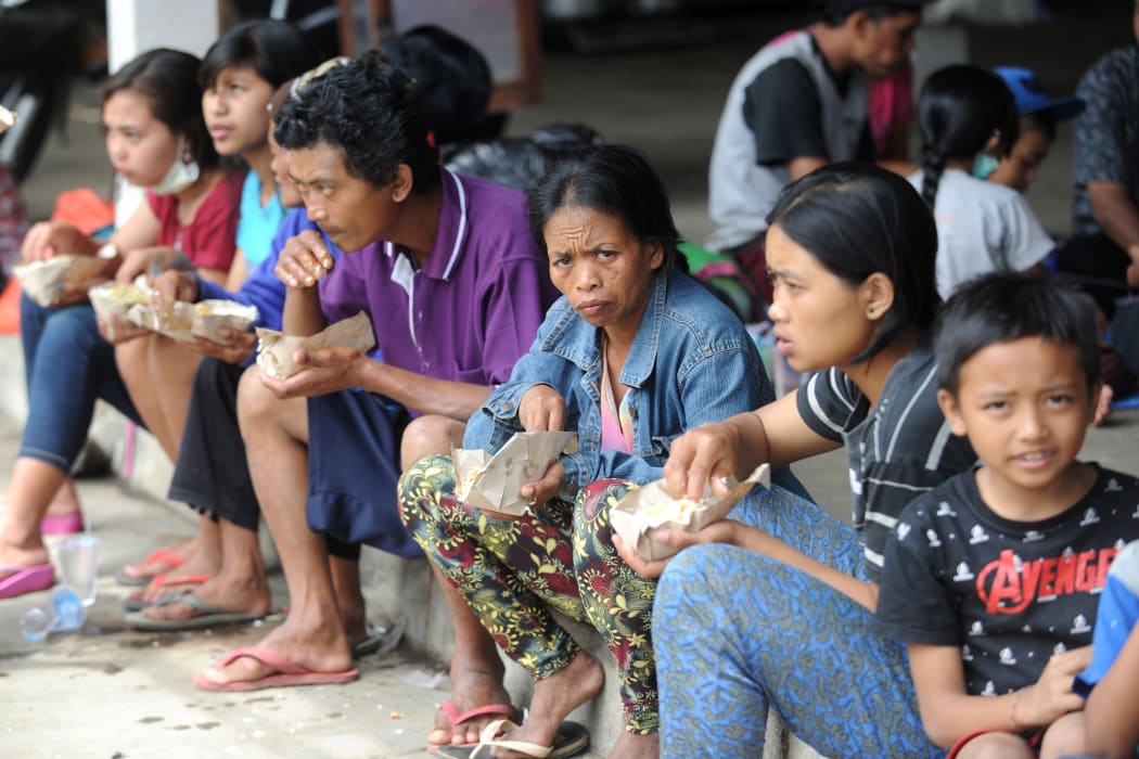 Villagers eat at an evacuation centre in Karangasem on the Indonesian resort island of Bali.