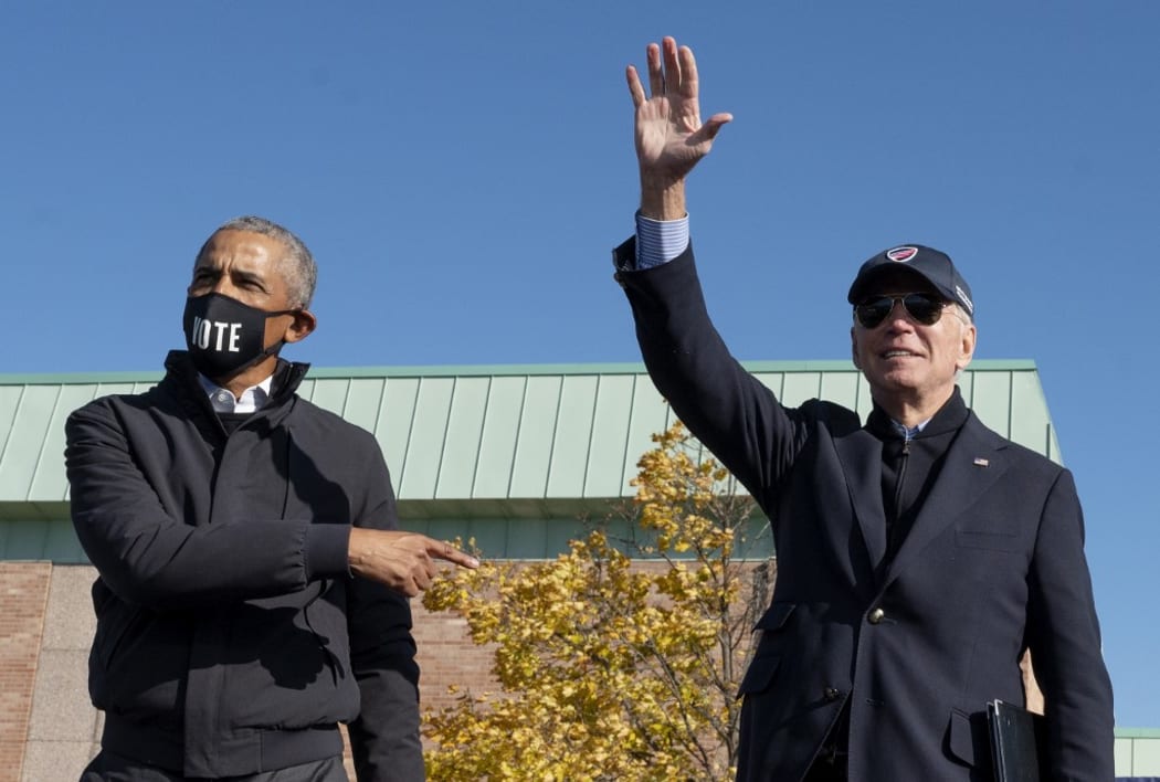 Former US President Barack Obama (L) joins Democratic presidential candidate Joe Biden at a campaign event in Flint, Michigan, on October 31, 2020.