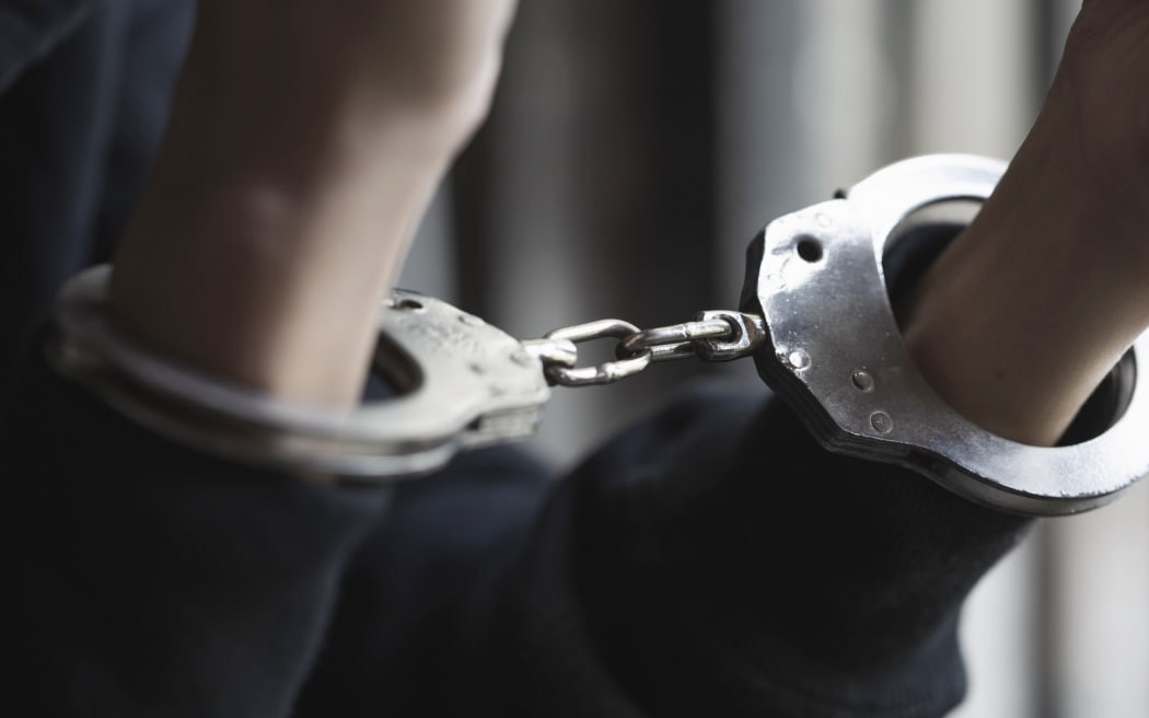 A pair of hands in cuffs.