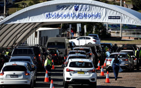 Health staff register residents at a Covid-19 coronavirus drive-through testing site on Bondi Beach in Sydney on 17 June 2021, after four positive cases.