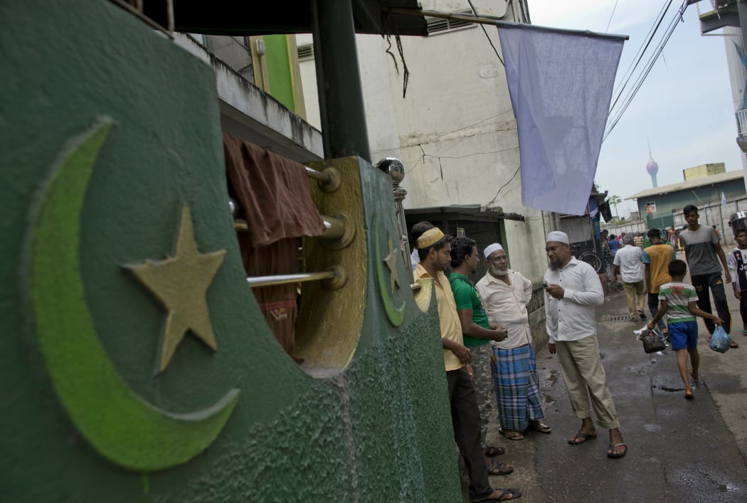 Muslim men gather outside a mosque in Colombo, Sri Lanka, on Friday 26 April.