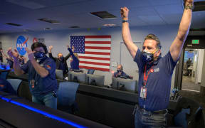 NASA's Perseverance rover team cheer and applaud afterreceiving confirmation the spacecraft successfully touched down on Mars on 18 February 2021.