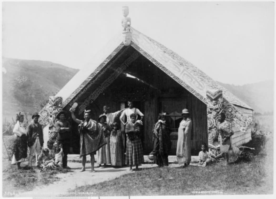 An unidentified Maori group in front of the Hinemihi meeting house at Te Wairoa in the 1880s.