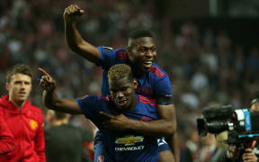 Manchester United's Paul Bogba (bottom) and Timothy Fosu-Mensah (top) celebrate their Europa win.