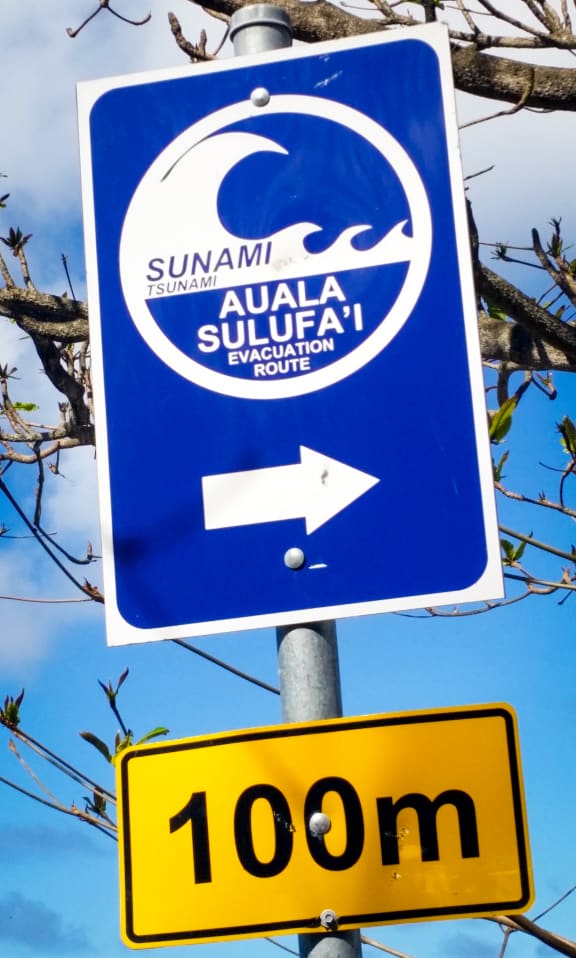 A sign on the beach directs people to the tsunami escape route.