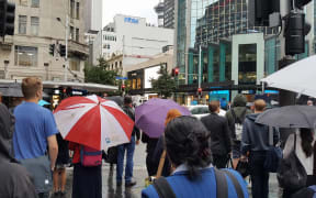 A sea of umbrellas as rain falls in the Auckland CBD